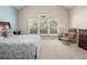 Sunlit bedroom boasts a vaulted ceiling, large window, and comfortable seating area at 10631 Clarke Farms Dr, Parker, CO 80134