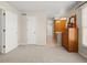 Bedroom showing neutral walls, carpet, and an en suite bathroom with oak cabinets at 10631 Clarke Farms Dr, Parker, CO 80134