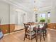 Elegant dining room with decorative lighting, tray ceiling, and large windows at 10631 Clarke Farms Dr, Parker, CO 80134