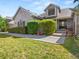 Charming home featuring a well-manicured lawn and inviting front entrance with decorative plants and flowers at 10631 Clarke Farms Dr, Parker, CO 80134
