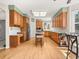 Spacious kitchen features warm wood cabinetry, a center island, and modern appliances at 10631 Clarke Farms Dr, Parker, CO 80134
