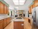 Spacious kitchen featuring center island, stainless appliances, and seamless flow into living space at 10631 Clarke Farms Dr, Parker, CO 80134