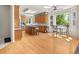 Open kitchen with wood floors, central island, breakfast area, and plenty of natural light at 10631 Clarke Farms Dr, Parker, CO 80134