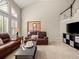 Inviting living room featuring vaulted ceilings, an abundance of natural light, and comfortable furnishings at 10631 Clarke Farms Dr, Parker, CO 80134