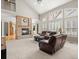 Bright living room with fireplace, vaulted ceilings, large windows, plush furniture, and an open layout at 10631 Clarke Farms Dr, Parker, CO 80134