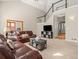 Bright living room with vaulted ceilings, an adjacent office and ample seating, bathed in natural light at 10631 Clarke Farms Dr, Parker, CO 80134