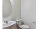 Powder room featuring a pedestal sink and white fixtures at 27574 E Byers Ave, Aurora, CO 80018