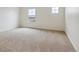 Spacious bedroom with carpet, neutral walls, and window offering scenic views of the surrounding landscape at 27574 E Byers Ave, Aurora, CO 80018