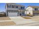 Two-story home featuring a two-car garage and charming front porch at 27574 E Byers Ave, Aurora, CO 80018