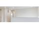 Upstairs hallway featuring neutral walls, carpet, a view to the outside, and access to other rooms at 27574 E Byers Ave, Aurora, CO 80018
