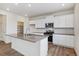 Modern kitchen features white cabinets, stainless steel appliances, a center island and large walk-in pantry at 27574 E Byers Ave, Aurora, CO 80018