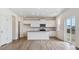 Bright kitchen with white cabinets, center island, and modern lighting at 27574 E Byers Ave, Aurora, CO 80018