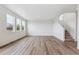 Bright living room featuring hardwood floors, neutral walls, and multiple windows allowing for ample natural light at 27574 E Byers Ave, Aurora, CO 80018