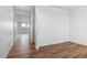 Open-concept living area with bright white walls and wood-look flooring at 27574 E Byers Ave, Aurora, CO 80018