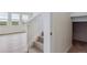 Carpeted staircase ascending to the upper level, offering access to the home's living spaces at 27574 E Byers Ave, Aurora, CO 80018