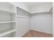 A spacious walk-in closet features custom shelving and ample rod space for optimal organization at 27574 E Byers Ave, Aurora, CO 80018