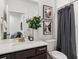 Well-lit bathroom features a vanity with a sink, mirror, and stylish decor at 2036 S Vance Way, Lakewood, CO 80227