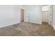 Spacious bedroom with neutral carpet leading to multiple doors at 2036 S Vance Way, Lakewood, CO 80227