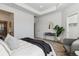 Bright bedroom features a cozy chair, stylish lamps, and a comfortable bed with elegant bedding at 2036 S Vance Way, Lakewood, CO 80227