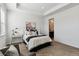 Bright bedroom features a cozy chair, stylish lamps, and a comfortable bed with elegant bedding at 2036 S Vance Way, Lakewood, CO 80227