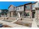 Townhome exterior featuring stone accents, a front porch, and well-maintained landscaping at 2036 S Vance Way, Lakewood, CO 80227