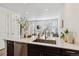 Bright, airy kitchen overlooking the living area with stainless steel appliances and a modern sink at 2036 S Vance Way, Lakewood, CO 80227