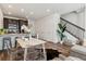 Open living space with modern decor adjacent to an eat-in kitchen and a staircase at 2036 S Vance Way, Lakewood, CO 80227
