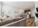 Open-concept living room and kitchen with modern furniture, stainless steel appliances, and plenty of natural light at 2036 S Vance Way, Lakewood, CO 80227