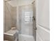 Stylish shower features tiled walls, a built-in seat, and a glass door at 2036 S Vance Way, Lakewood, CO 80227