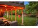 Covered patio with outdoor seating, a swing, and a view of the grassy backyard at 9810 Townsville Cir, Highlands Ranch, CO 80130