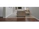 Cozy basement living area with hardwood flooring, plush carpet, and custom built-in shelving at 9810 Townsville Cir, Highlands Ranch, CO 80130