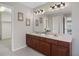 Bathroom featuring double sinks, a large mirror, and decorative vanity lighting at 9810 Townsville Cir, Highlands Ranch, CO 80130