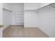 Walk-in closet with neutral carpet, white walls, and shelving and hanging rod for storage at 9810 Townsville Cir, Highlands Ranch, CO 80130