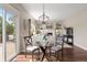 Dining area with a glass table, deck access, and a cozy fireplace in the background at 9810 Townsville Cir, Highlands Ranch, CO 80130