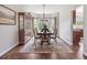 Bright dining room featuring a stylish chandelier and a bay window with backyard views at 9810 Townsville Cir, Highlands Ranch, CO 80130