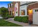 Close-up of a home's entrance with a charming walkway, lush landscaping, and a welcoming front door at 9810 Townsville Cir, Highlands Ranch, CO 80130