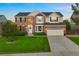 Beautiful brick home with a manicured lawn, a two car garage, and a welcoming front door at 9810 Townsville Cir, Highlands Ranch, CO 80130
