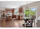 Open kitchen and dining area with deck access and beautiful backyard views at 9810 Townsville Cir, Highlands Ranch, CO 80130