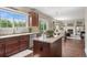 Modern kitchen with an island and seamless flow to a dining area and Gathering room at 9810 Townsville Cir, Highlands Ranch, CO 80130