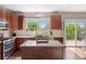 Updated kitchen with stainless steel appliances, a center island, and sliding door access to the backyard at 9810 Townsville Cir, Highlands Ranch, CO 80130