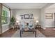 Cozy living room with neutral decor, hardwood floors and a large window at 9810 Townsville Cir, Highlands Ranch, CO 80130
