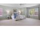 Bright main bedroom boasts a large window, neutral carpet, and a decorative, brass bed frame at 9810 Townsville Cir, Highlands Ranch, CO 80130