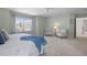 Spacious main bedroom has a ceiling fan, neutral carpet, and a large window with neighborhood views at 9810 Townsville Cir, Highlands Ranch, CO 80130