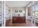 Office space featuring hardwood floors, bookshelves, and a bay window at 9810 Townsville Cir, Highlands Ranch, CO 80130