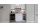 Modern wet bar with sleek cabinetry, under-cabinet lighting, beverage cooler and dedicated wine storage at 9810 Townsville Cir, Highlands Ranch, CO 80130