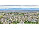 Expansive aerial view of a neighborhood with lush greenery and stunning mountain views at 23070 York Ave, Parker, CO 80138