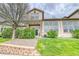 Back exterior of home with lawn, greenery, and an entrance sliding door at 23070 York Ave, Parker, CO 80138