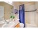 Bright bathroom with tile accents, a vanity, and a shower/tub combination at 23070 York Ave, Parker, CO 80138