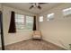Neutral bedroom featuring carpeted floors, two windows, and a chair at 23070 York Ave, Parker, CO 80138