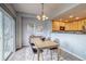Cozy dining area featuring a wooden table, modern light fixture, and view into the kitchen at 23070 York Ave, Parker, CO 80138